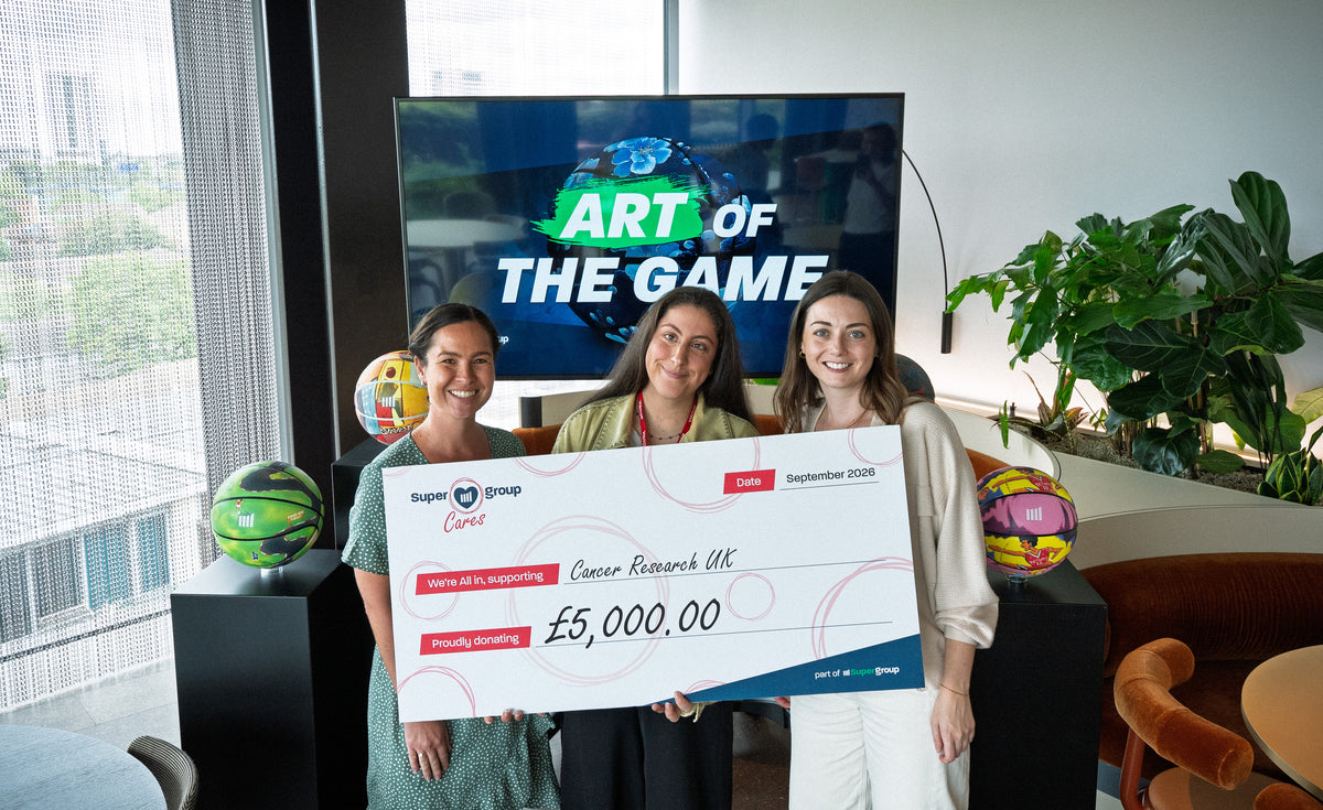 Emily Green being presented with a cheque for her chosen charity, Cancer Research UK.